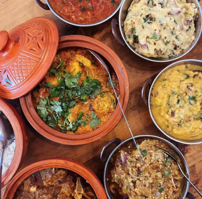 table spread of colorful Bengali dishes