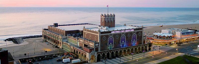 A brick building overlooking water with the headline "GREETINGS FROM ASBURY PARK", in Asbury Park, New Jersey