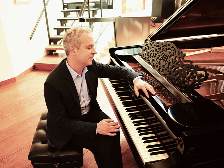 Jeremy Denk sitting at piano