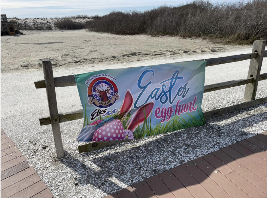 egg hunt banner on bench near beach