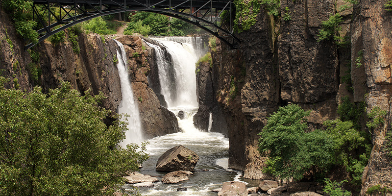 An under the bridge view of Great Falls waterfall in Patterson, New Jersey.