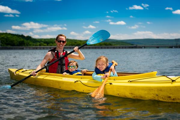 Mother with two small children kayaking