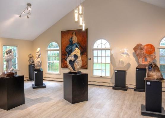 The Sanctuary Room displays stone sculptures and paintings in an open, airy space