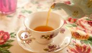 tea being poured into fine china tea cup