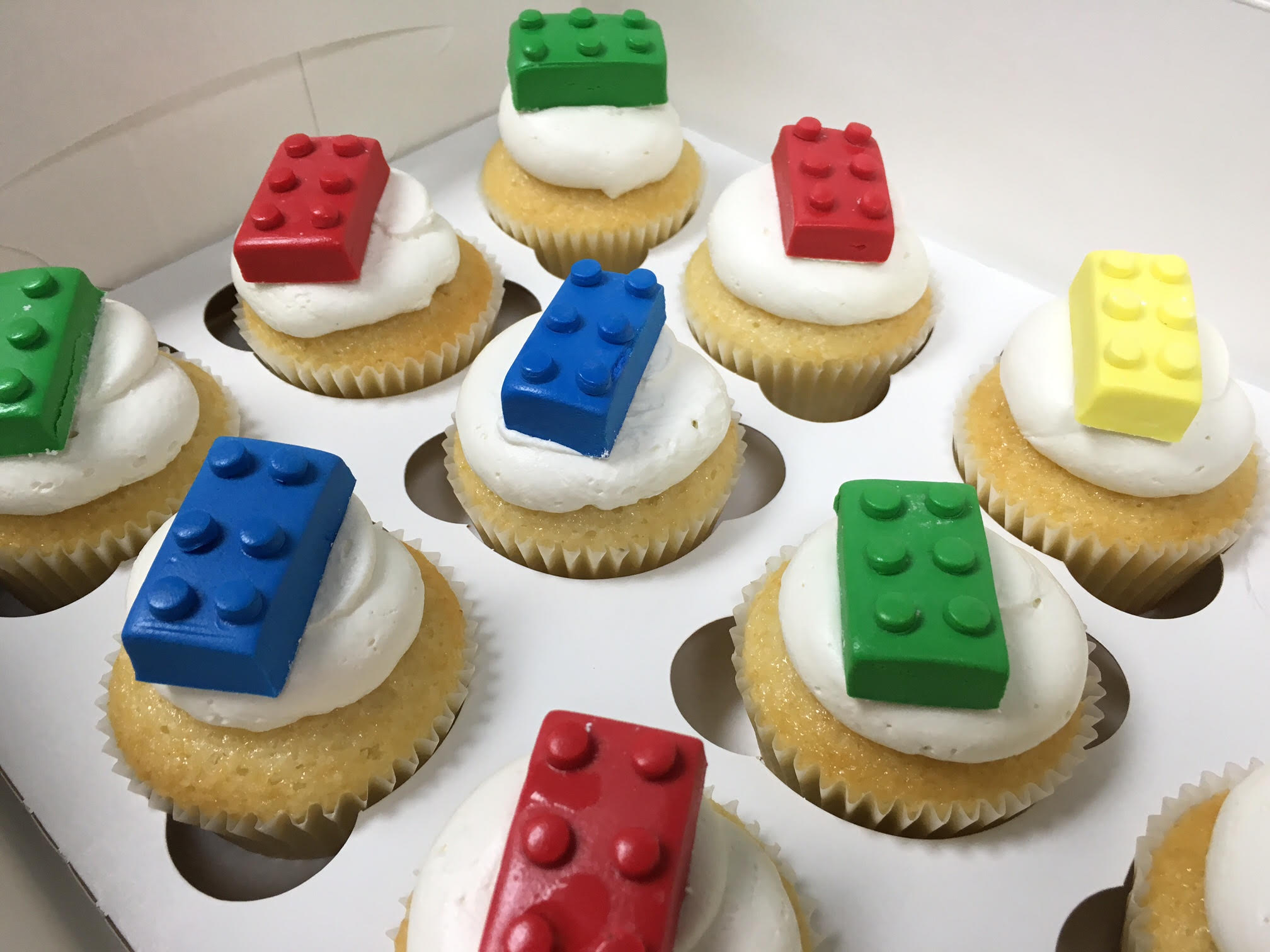 mini vanilla cupcakes with legos on them